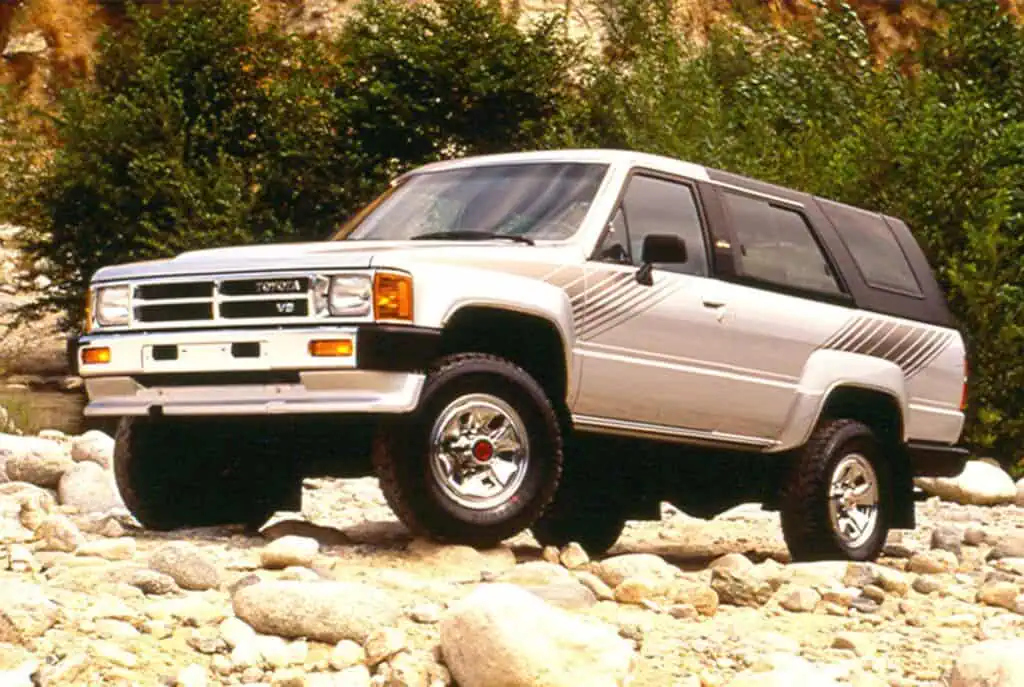 Vintage Toyota 4x4 off-road vehicle in rocky natural landscape, classic SUV with retro design and rugged tires, perfect for outdoor adventures and exploring wilderness.