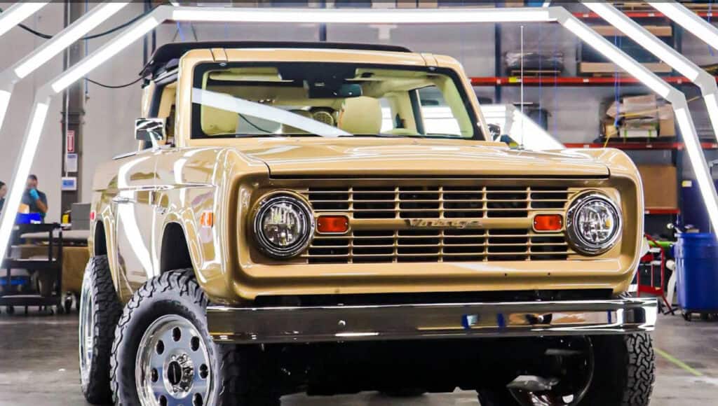 Gold vintage truck with modern upgrades in an industrial workshop setting, showcasing retro and industrial design elements, perfect for vintage modern decor styles.