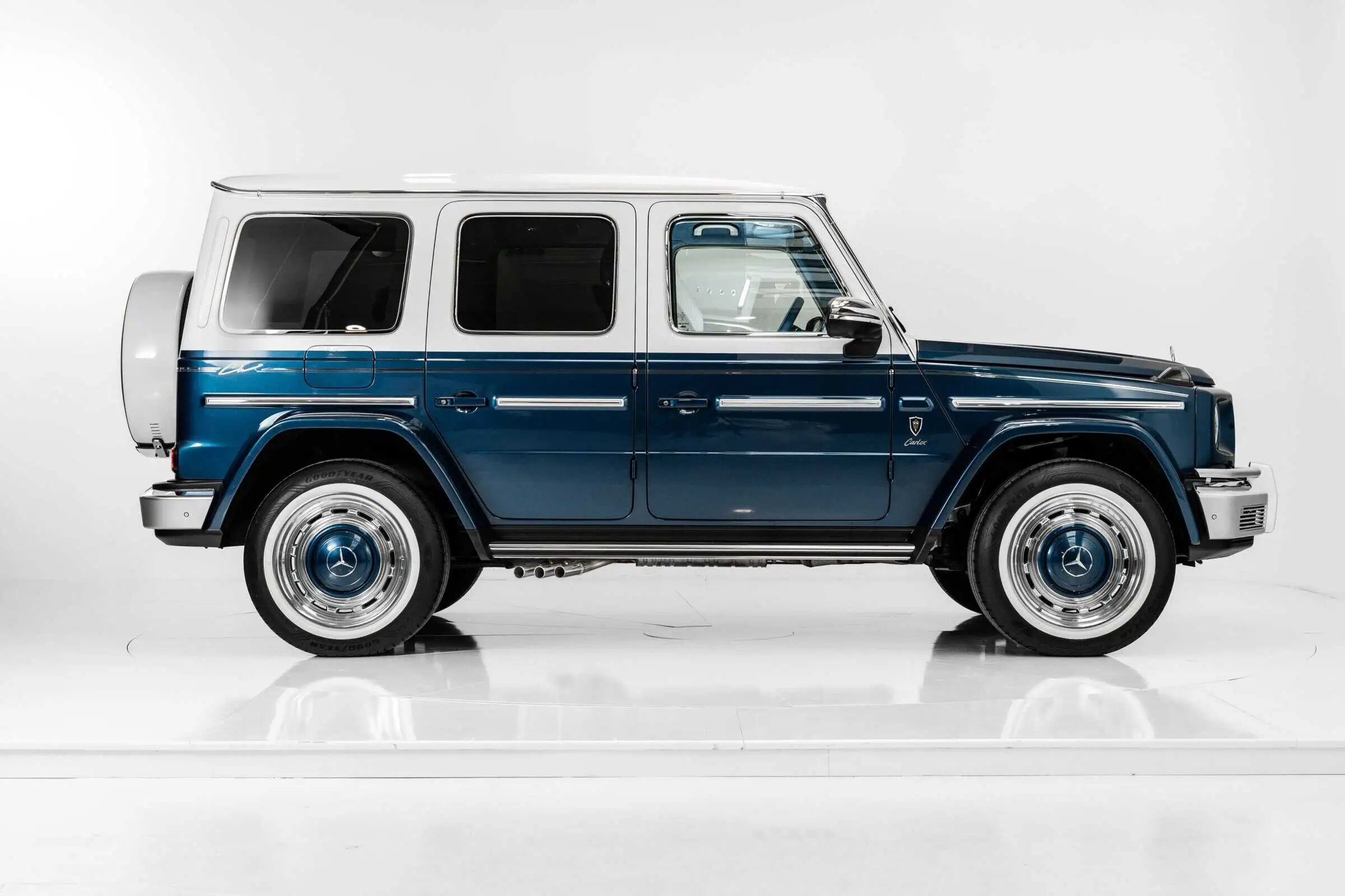 A classic luxury SUV with a retro-inspired design, featuring a blue and white exterior, sleek lines, and iconic Mercedes-Benz detailing for vintage modern aesthetics.